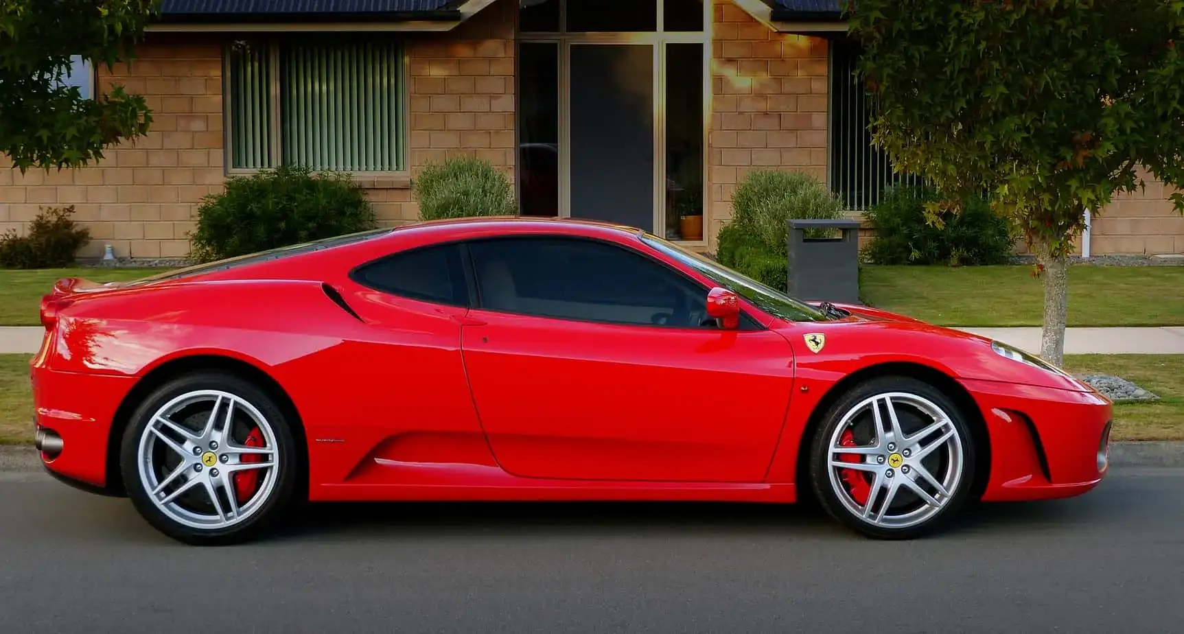 Hamilton exotic car on flatbed soft-strap transport