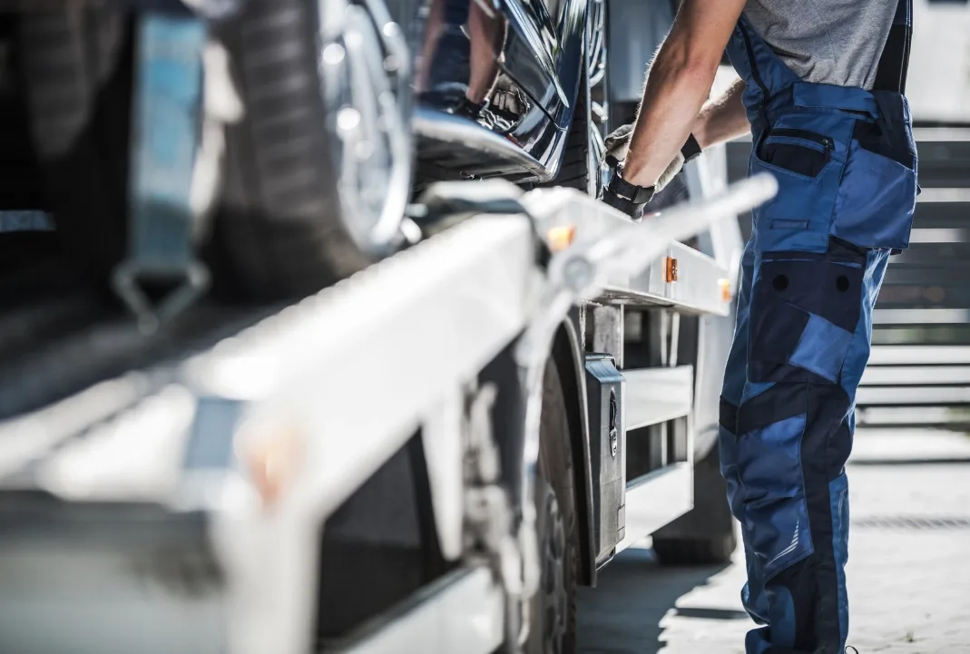 Hamilton tow truck driver loading a car onto a flatbed